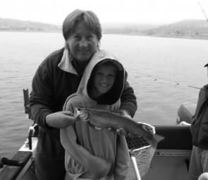 The author with Thomas Smith, 8, and a nice brown trout trolled up from the lake.